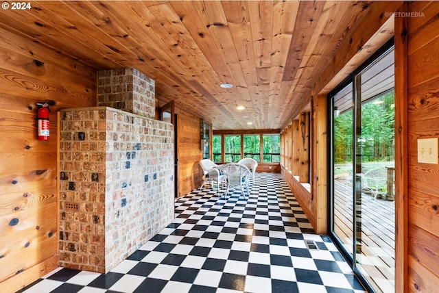 hallway with wood ceiling and wooden walls