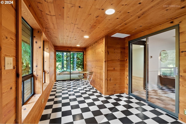 corridor featuring wood walls and wooden ceiling