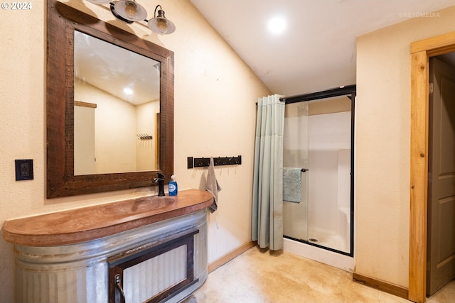 bathroom with vaulted ceiling, vanity, and a shower with curtain