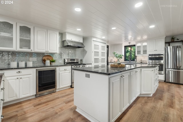 kitchen featuring wine cooler, appliances with stainless steel finishes, and white cabinetry