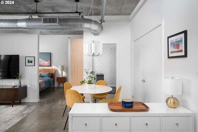 dining space with concrete flooring