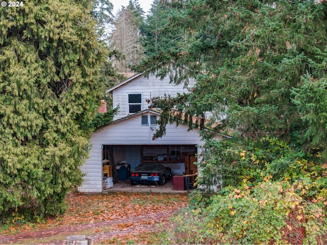 view of side of property with a garage and an outdoor structure