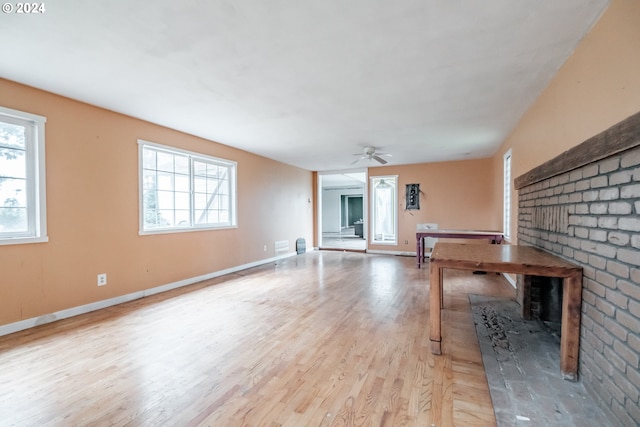 unfurnished living room with ceiling fan and light wood-type flooring