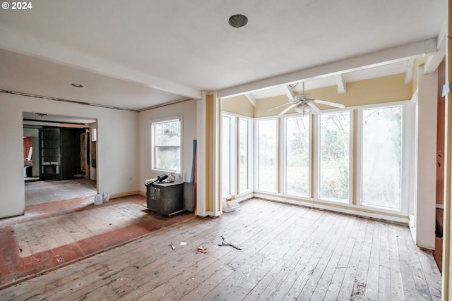 unfurnished room featuring vaulted ceiling with beams, light hardwood / wood-style flooring, and ceiling fan