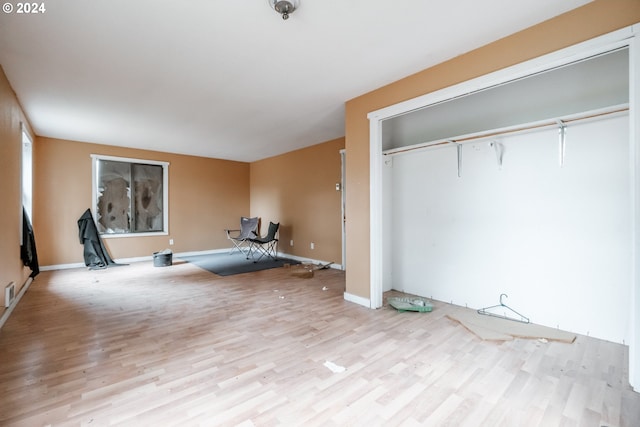 unfurnished bedroom featuring light wood-type flooring and a closet