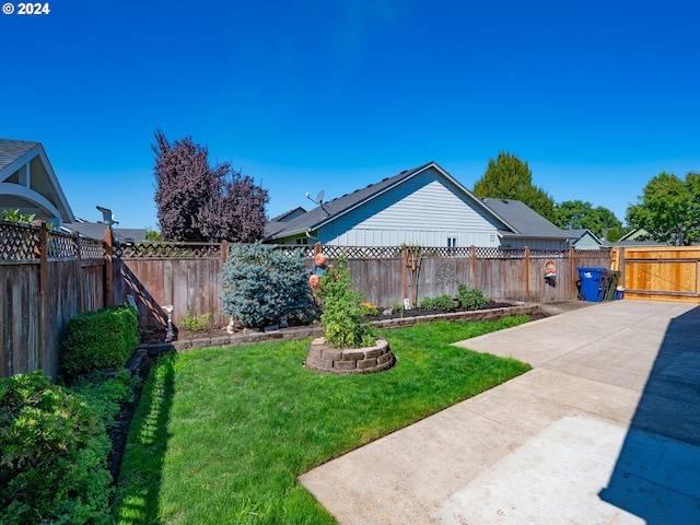 view of yard with a patio area and a fenced backyard