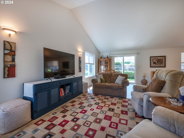 living area featuring light carpet and high vaulted ceiling