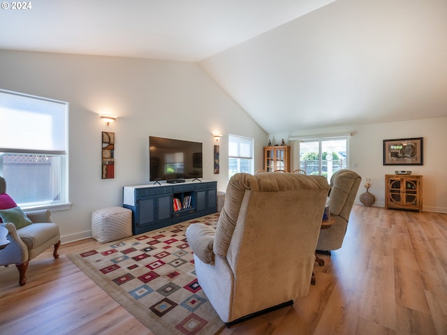 living room with light wood-type flooring and lofted ceiling