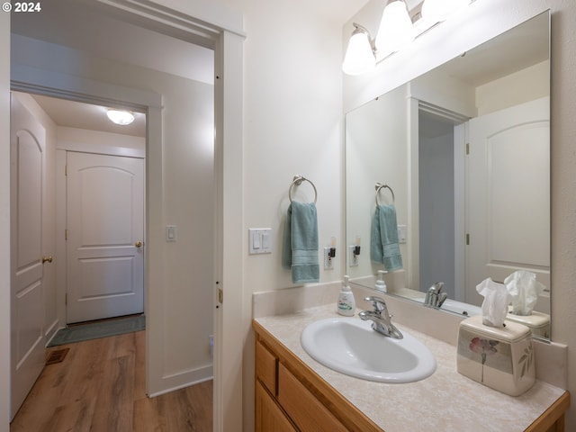 bathroom featuring visible vents, wood finished floors, and vanity