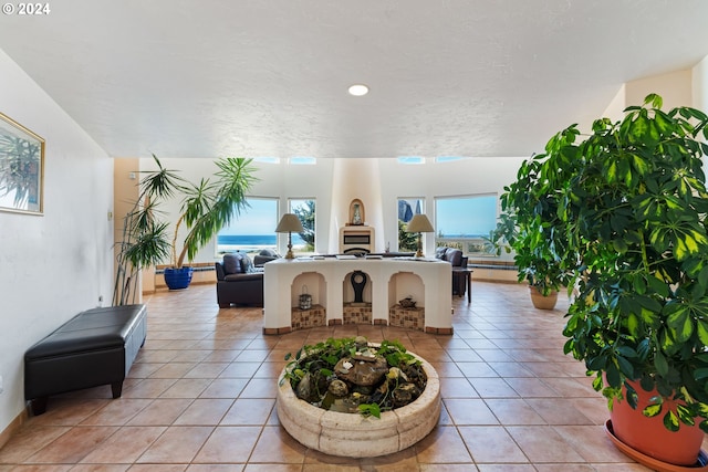 tiled living room featuring a wealth of natural light and a textured ceiling