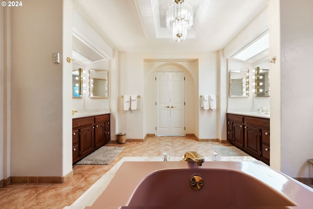 bathroom with vanity, a washtub, tile patterned floors, and a notable chandelier