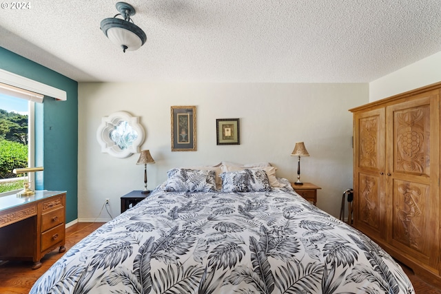 bedroom featuring wood-type flooring and a textured ceiling