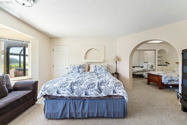 carpeted bedroom featuring a textured ceiling