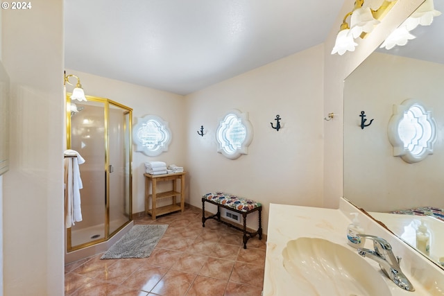 bathroom featuring vanity, tile patterned flooring, and a shower with shower door