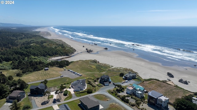 birds eye view of property with a beach view and a water view