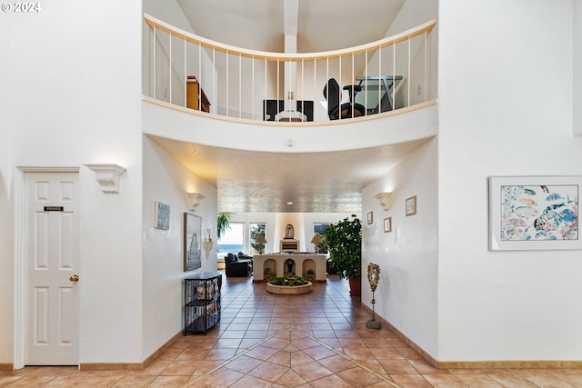 interior space featuring a high ceiling and light tile patterned floors