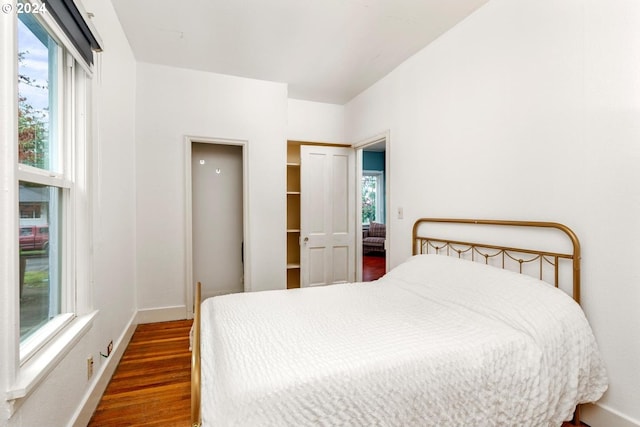 bedroom featuring a closet and dark wood-type flooring