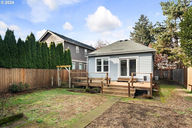 back of house with a lawn and a deck