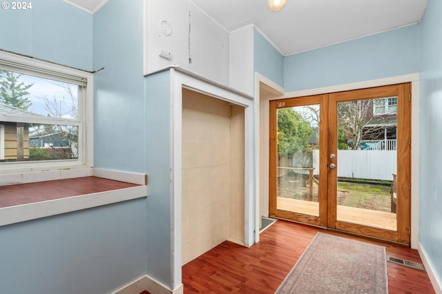 entryway with french doors and hardwood / wood-style flooring