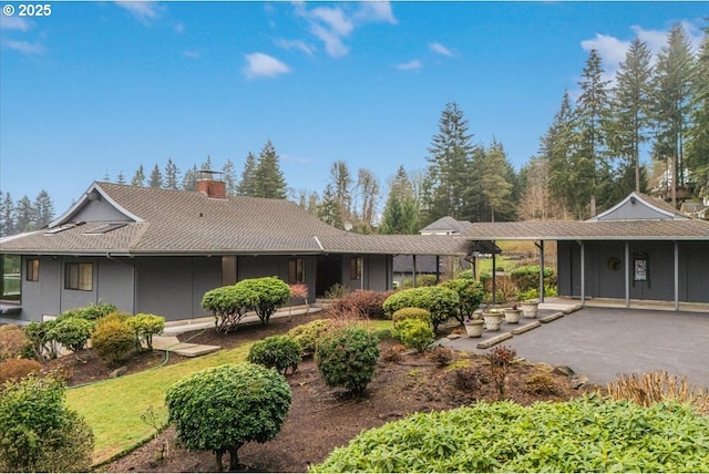 rear view of property featuring a carport