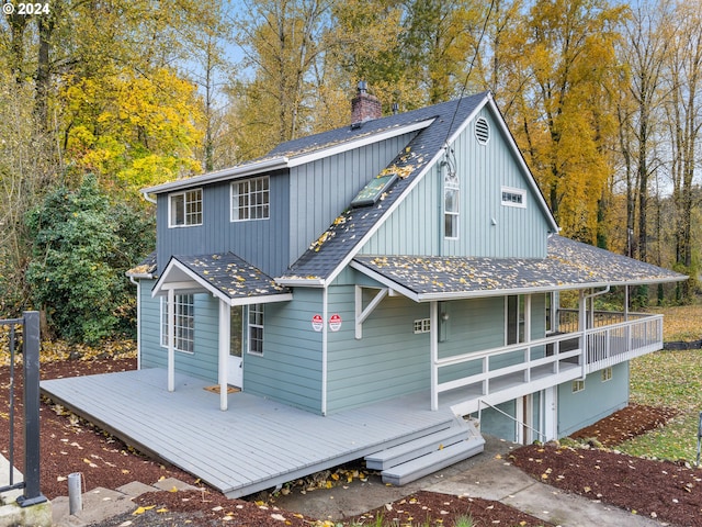 back of house featuring a wooden deck