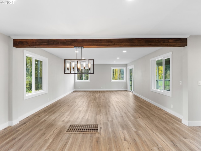 interior space featuring beam ceiling, a wealth of natural light, a notable chandelier, and light wood-type flooring