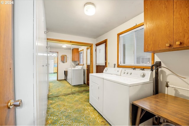 washroom with cabinets and independent washer and dryer