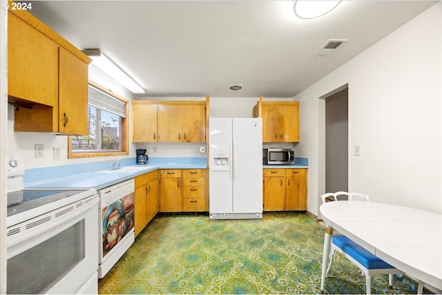 kitchen with white appliances and sink