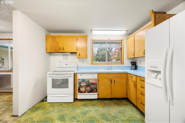 kitchen featuring white appliances and sink