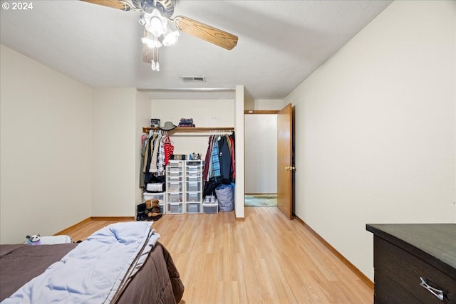 bedroom featuring ceiling fan, a closet, and light hardwood / wood-style floors