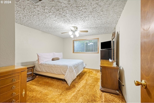 bedroom featuring carpet, a textured ceiling, and ceiling fan