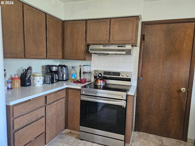 kitchen featuring decorative backsplash and stainless steel range with electric stovetop