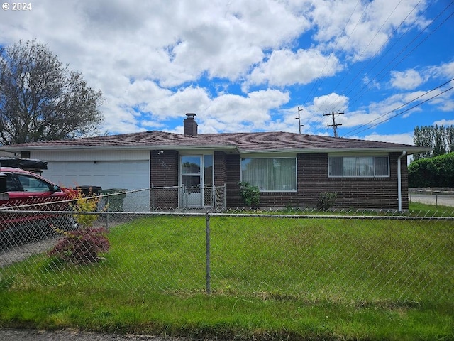 single story home with a garage and a front lawn