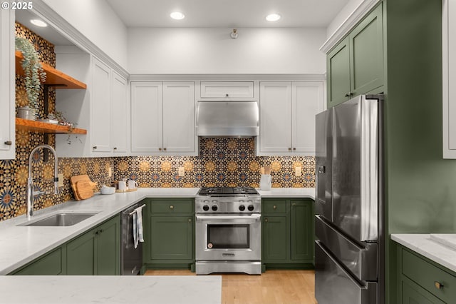 kitchen with sink, green cabinets, appliances with stainless steel finishes, extractor fan, and white cabinets