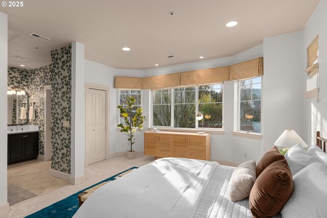 bedroom with ensuite bath and sink