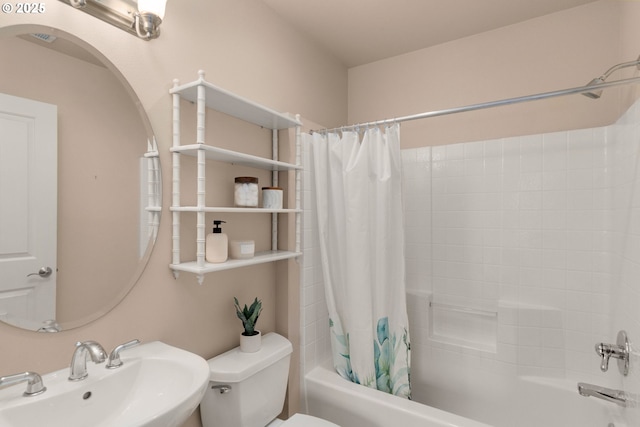 full bathroom with shower / tub combo with curtain, sink, and toilet