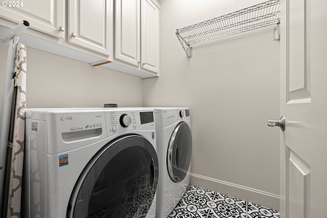 laundry room with cabinets, separate washer and dryer, and tile patterned flooring