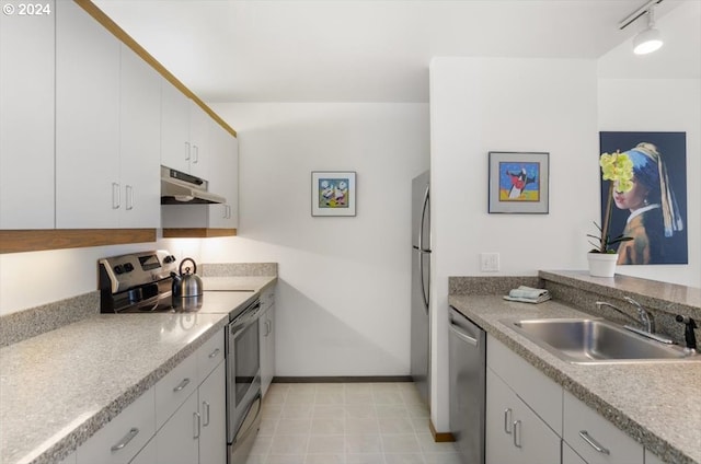 kitchen featuring white cabinetry, sink, stainless steel appliances, and track lighting