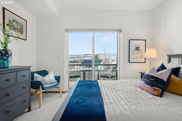 carpeted bedroom with access to outside and a water view