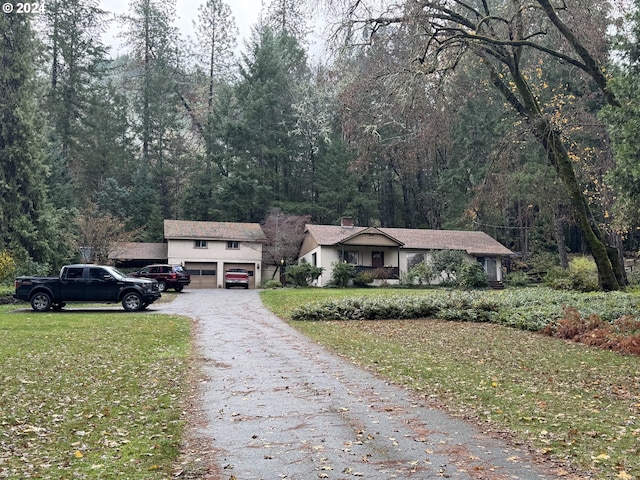 view of front of house featuring a front yard and a garage