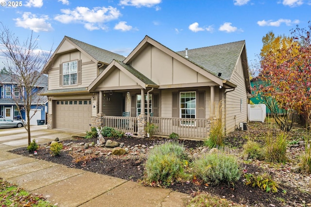 view of front of house featuring driveway, a shingled roof, a garage, and a porch