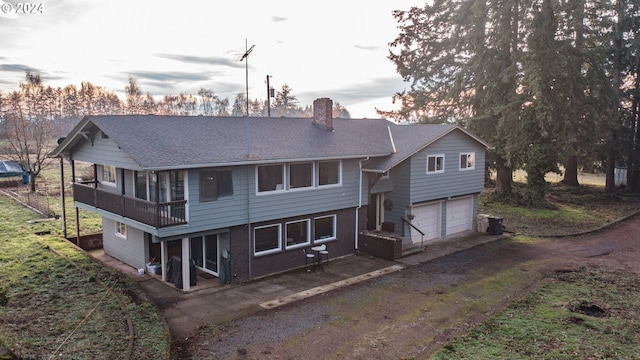 rear view of house featuring a garage