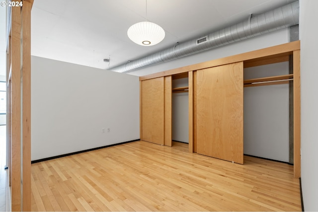 unfurnished bedroom with light wood-type flooring