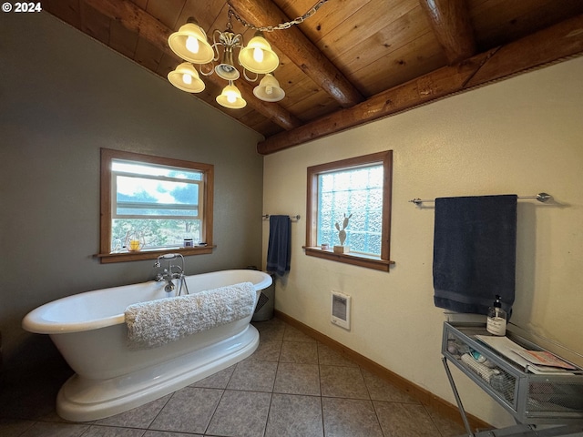 bathroom with vaulted ceiling with beams, a freestanding bath, a wealth of natural light, and baseboards