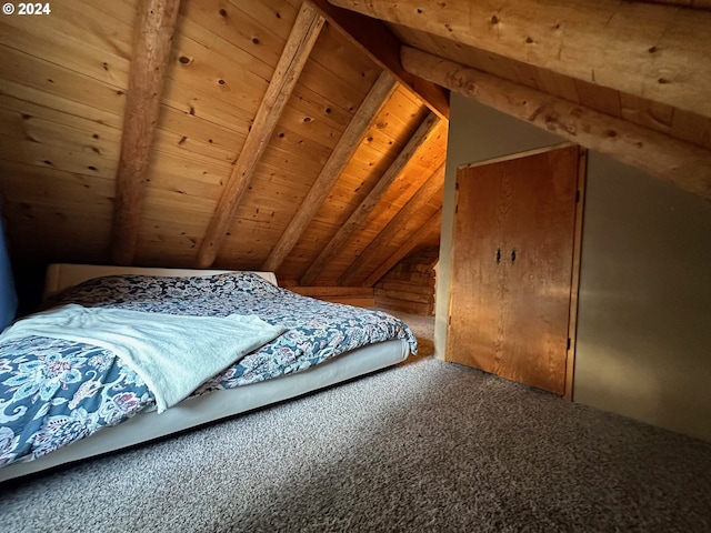 unfurnished bedroom featuring carpet floors, wooden ceiling, and vaulted ceiling with beams