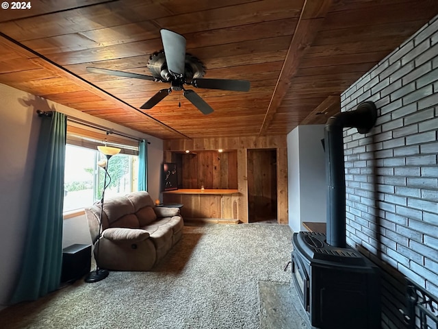 carpeted living room with a wood stove, wooden ceiling, and ceiling fan