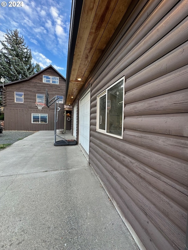 view of side of home featuring log veneer siding