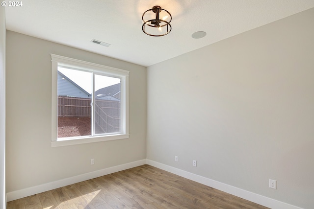 spare room featuring a healthy amount of sunlight and light wood-type flooring