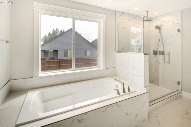 bathroom with plenty of natural light, tile flooring, and independent shower and bath