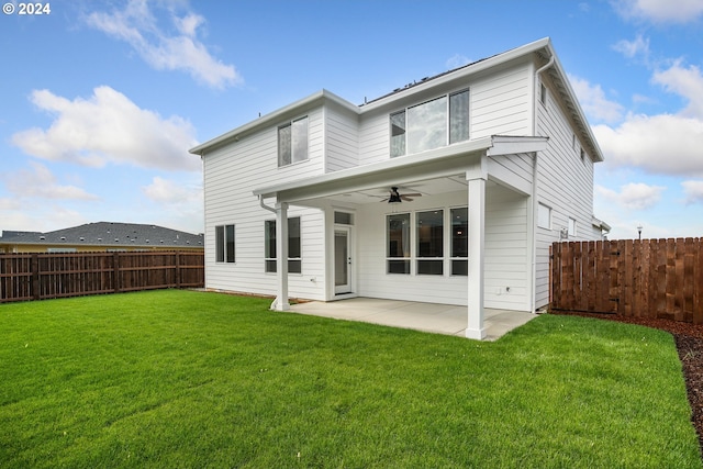 back of property featuring a patio area, a lawn, and ceiling fan